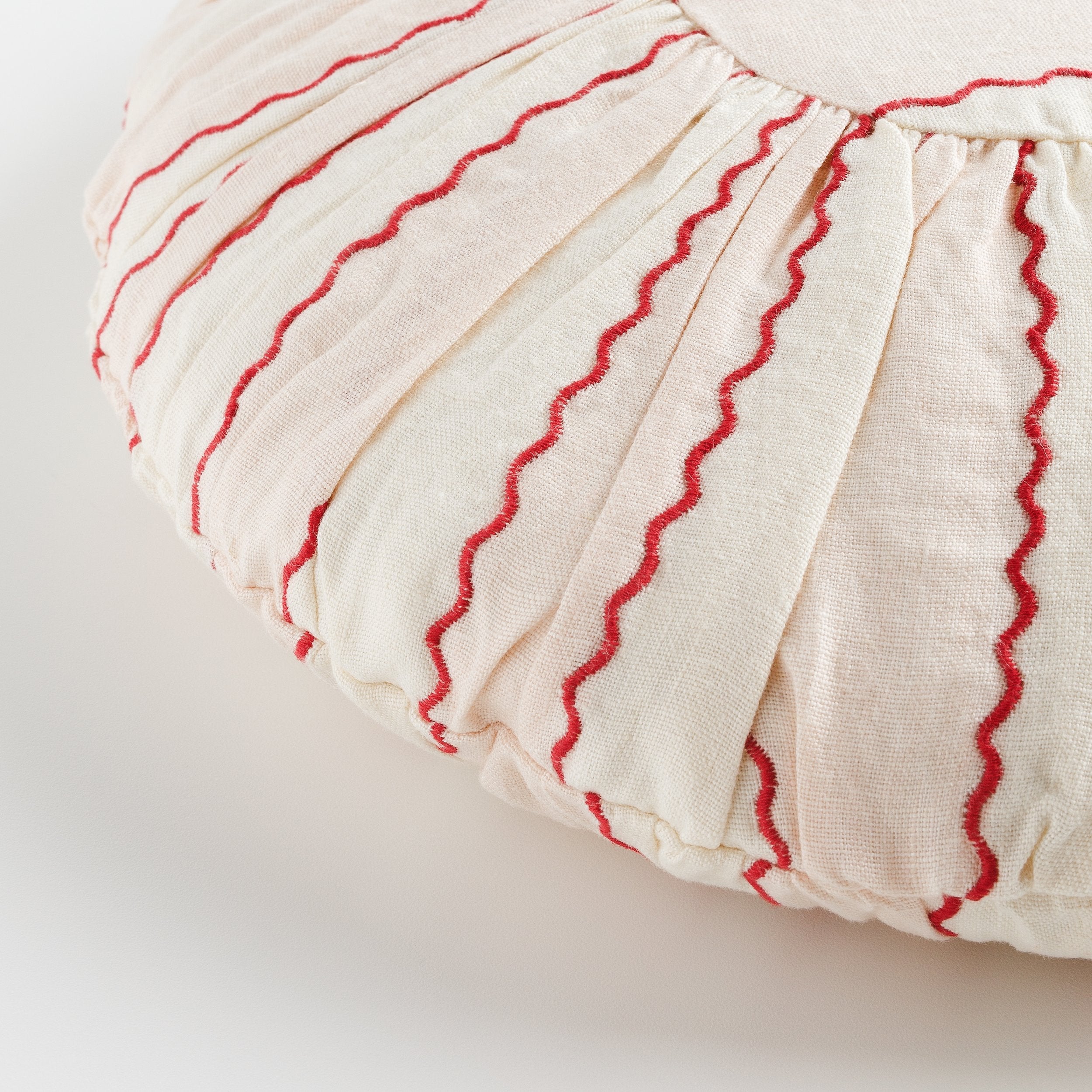 Marionette embroidered stripe round cushion, pink/cream