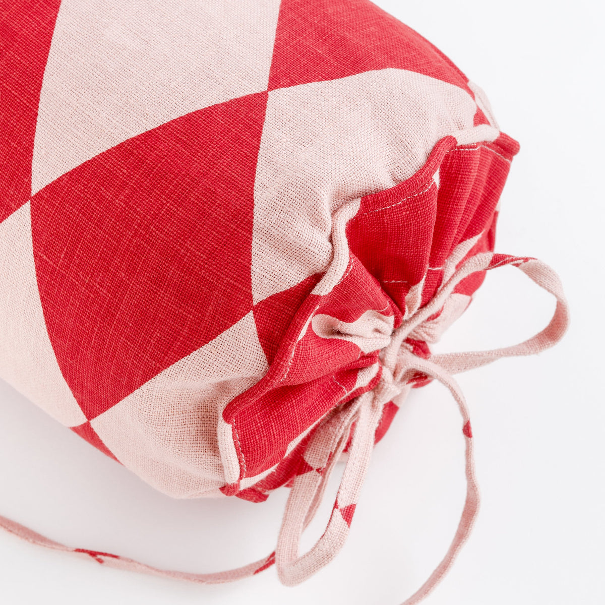 Harlequin linen bolster, red/pink